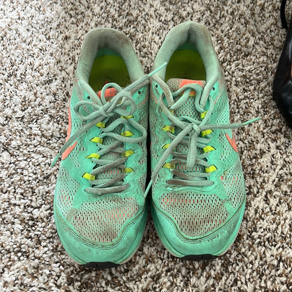 Mint green, neon green, and neon coral nike shoes